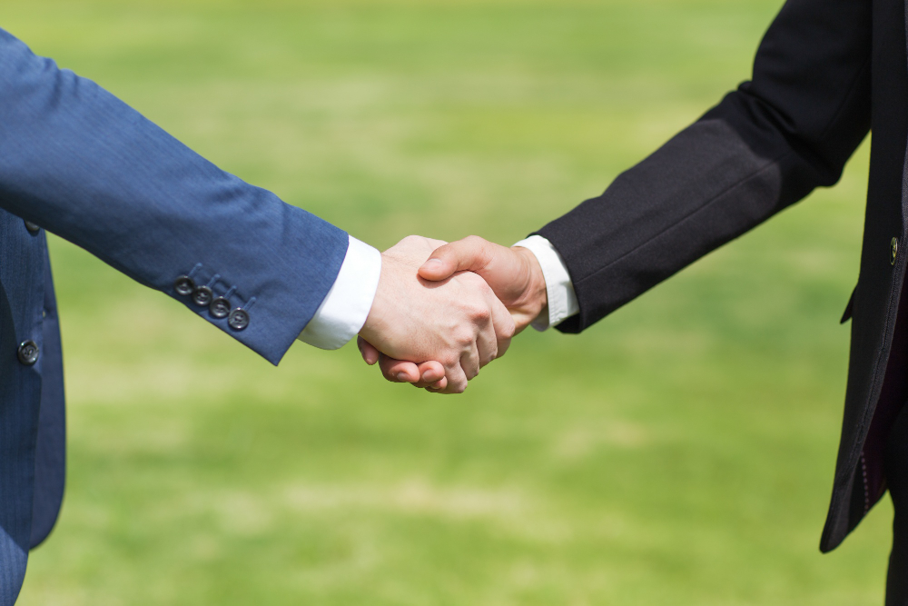 closeup two business men shaking hands BioEnergyTech Jordan